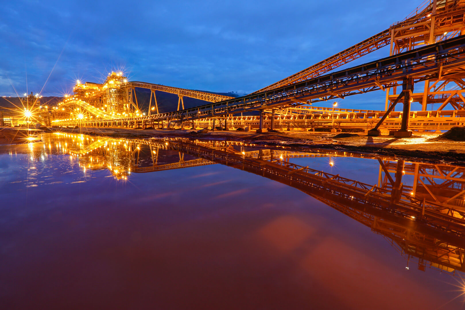 Iron-ore port and processing facility illuminated at dusk in Sierra Leone
