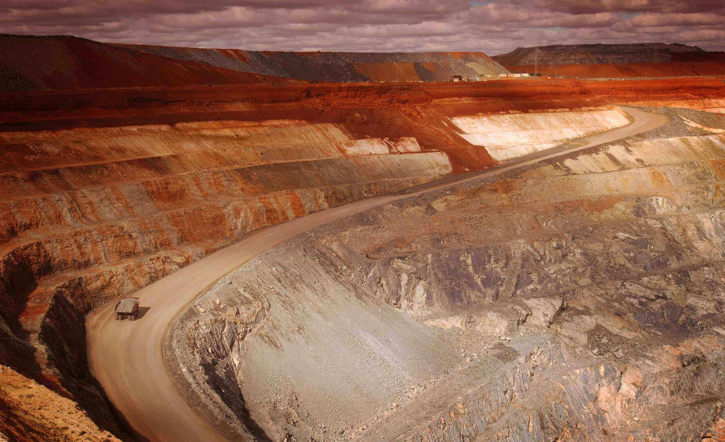 Haul trucks on a haul road in an open-pit mine