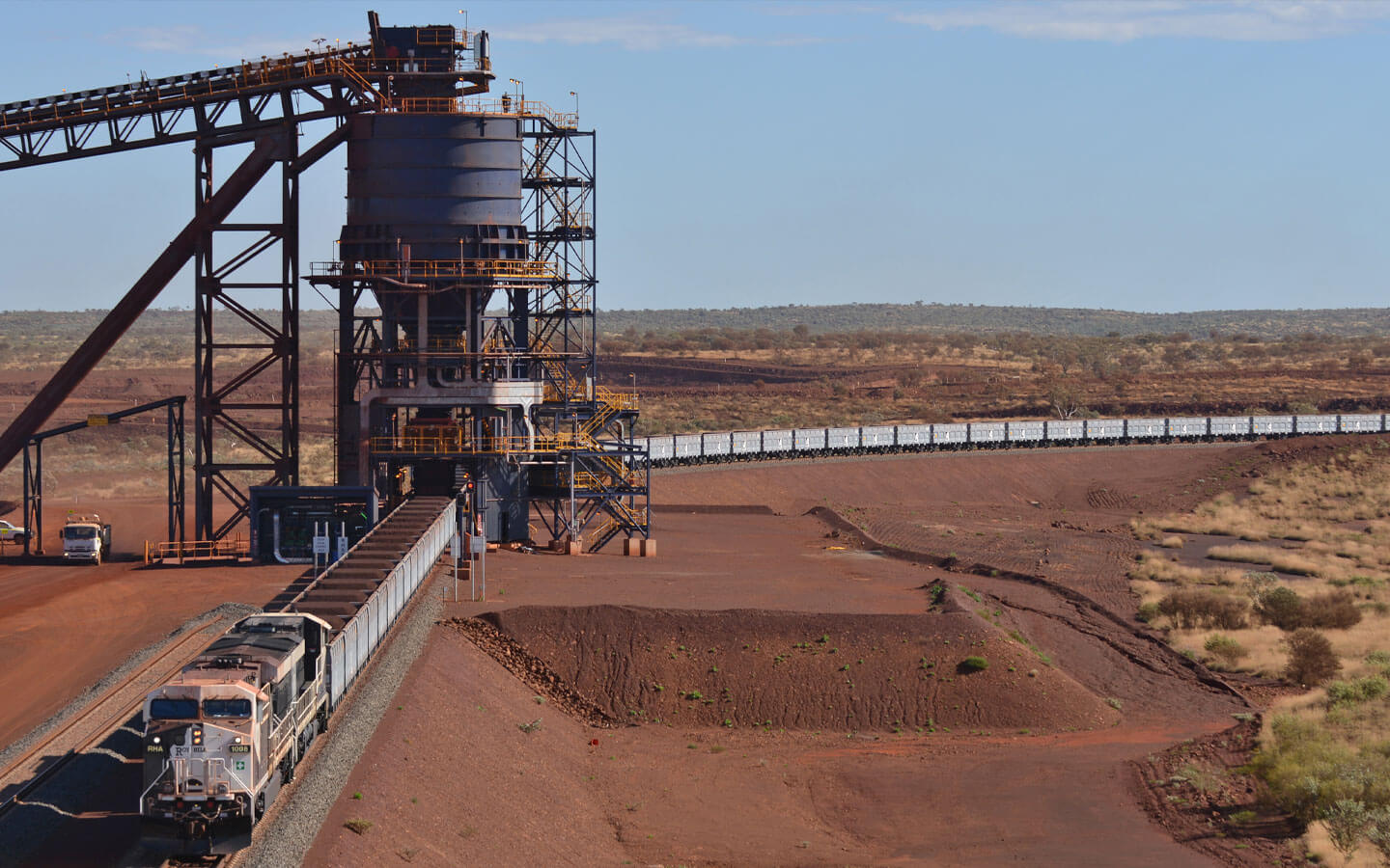 Iron ore train being loaded at a rail load-out facility at a Pilbara mining operation in Western Australia