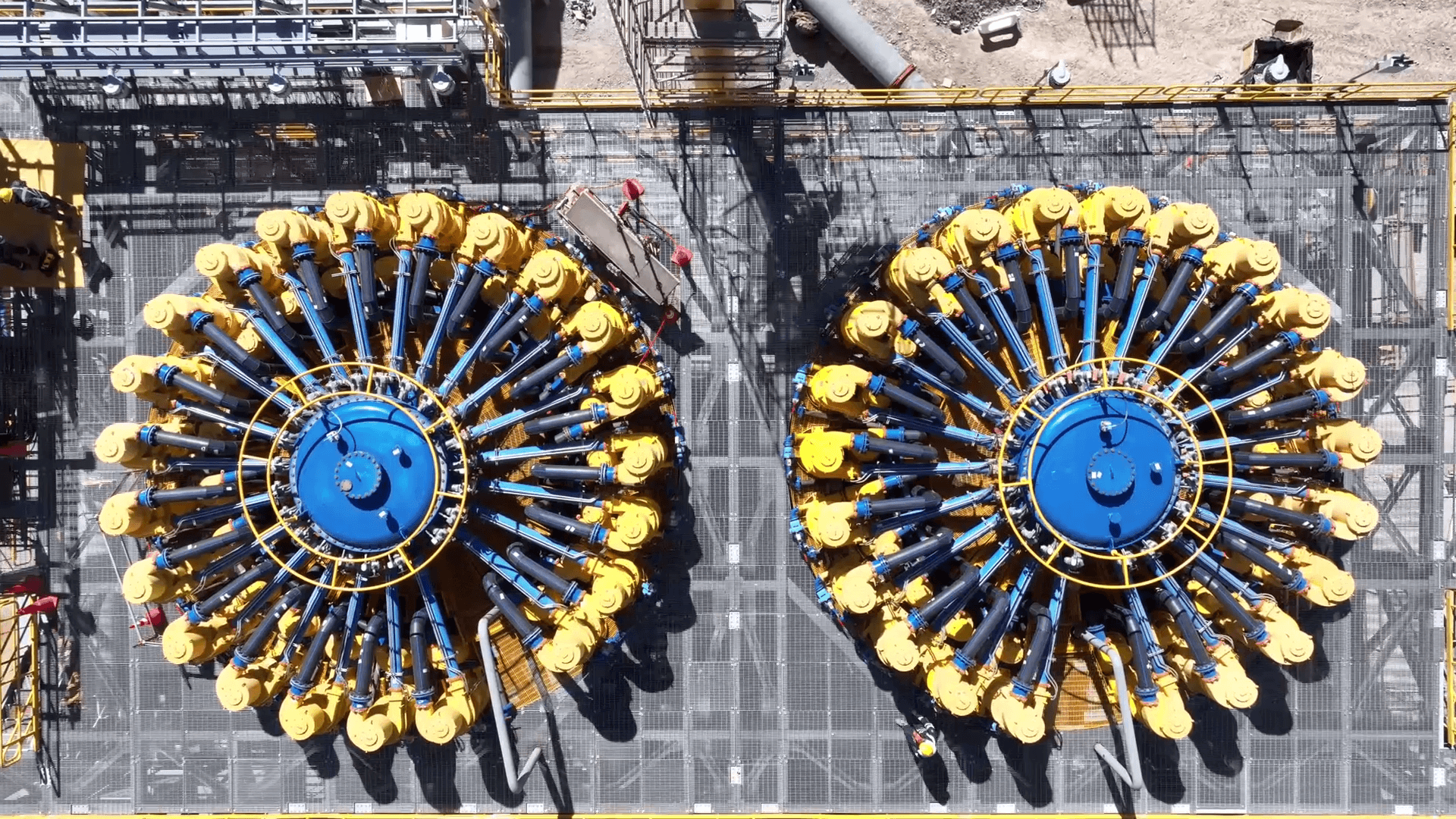 Overhead view of two large circular mineral processing units inside a mine concentrator plant